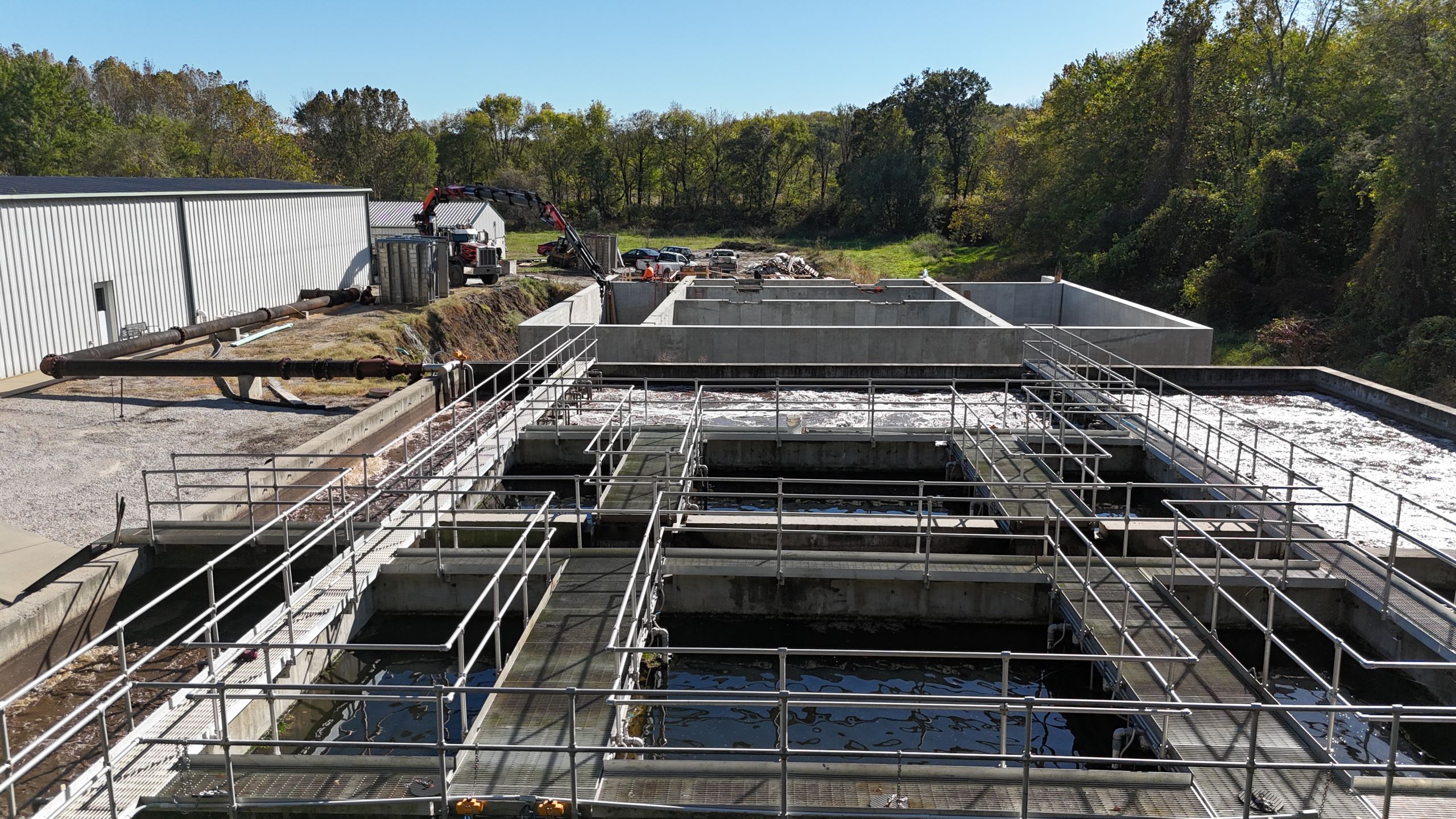 Perspective view of the Timber Creek Wastewater Treatment expansion in Kansas City, featuring steel walkways over active concrete aeration basins by Havens.