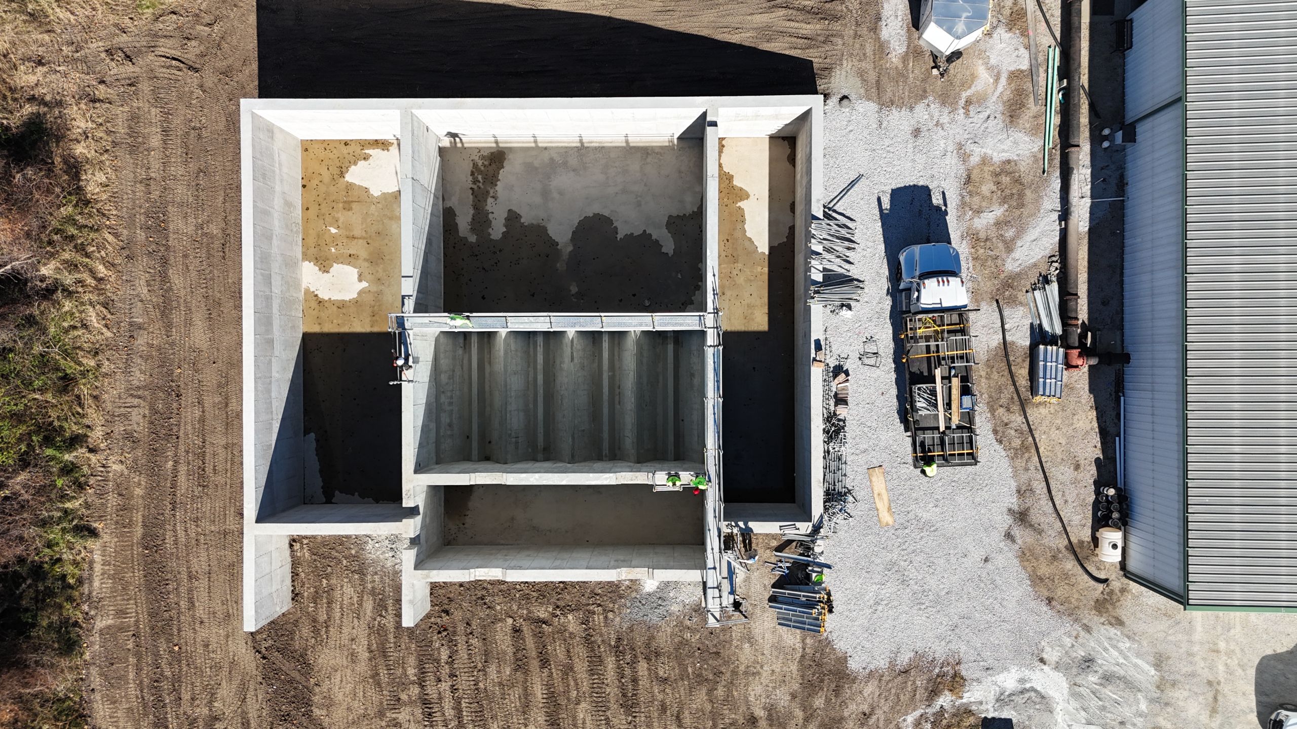 Aerial top-down view of the Timber Creek Wastewater Treatment plant expansion, showing detailed concrete tank construction and onsite staging by Havens.